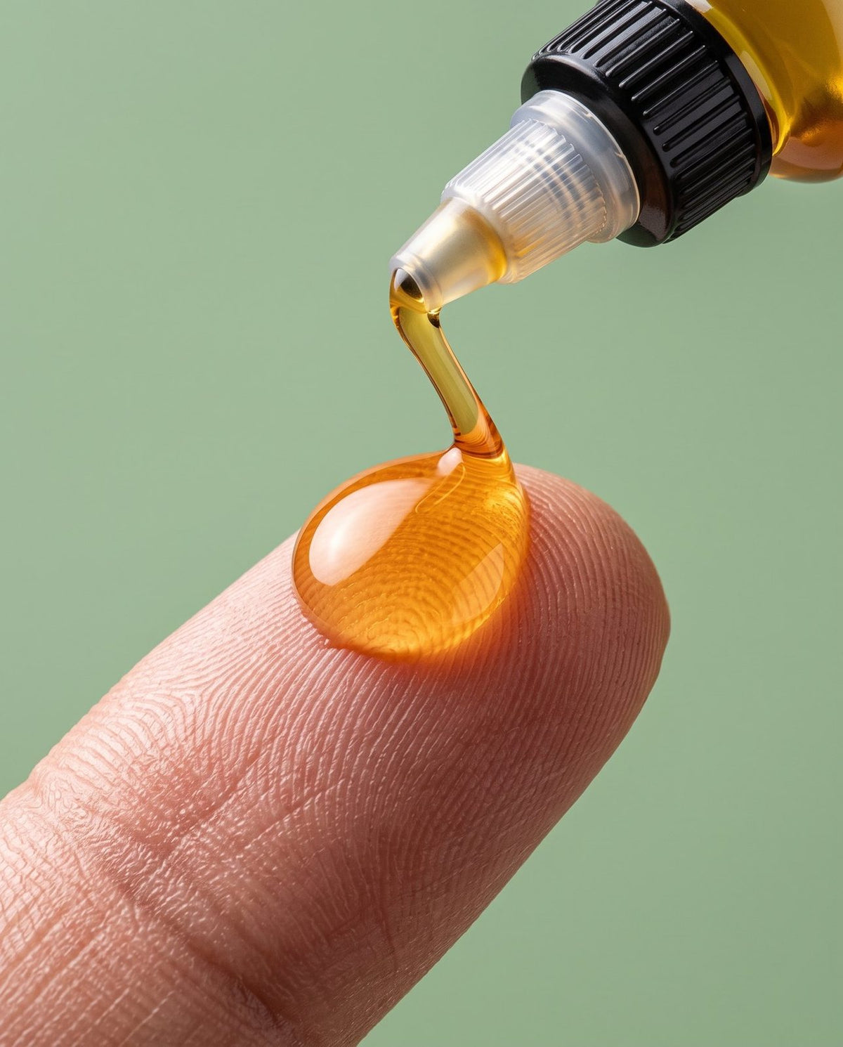 Close-up of batana oil texture on a fingertip